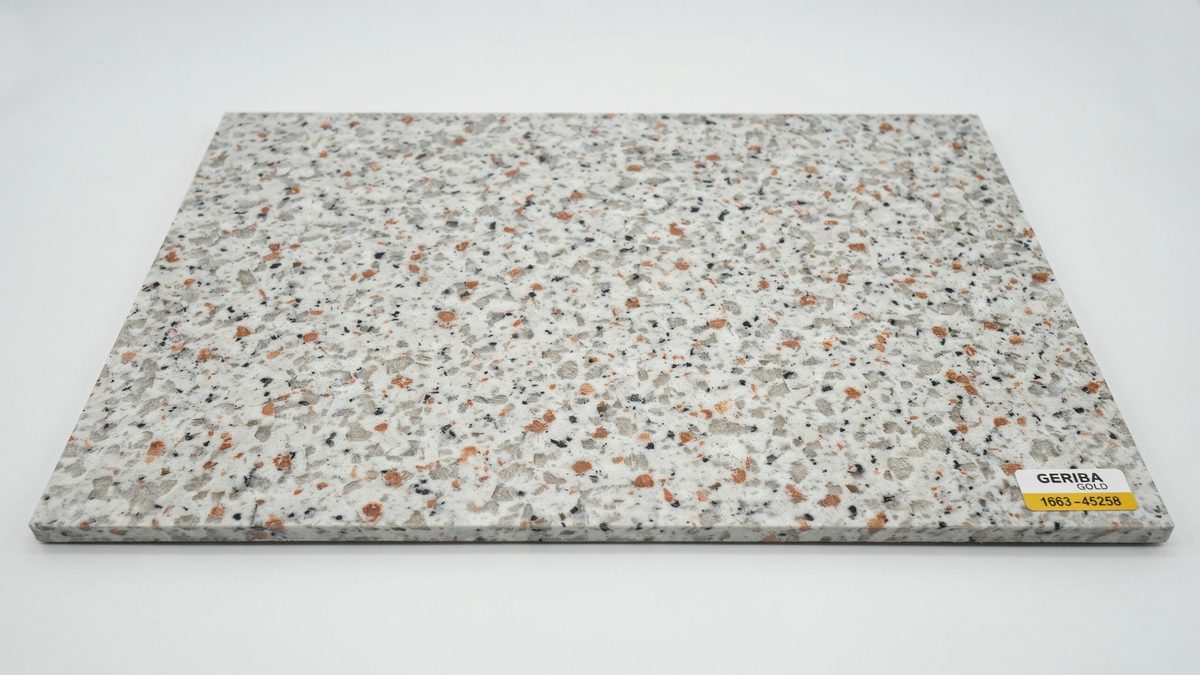 Gray laminate countertop sample speckled with orange black and white mineral flecks