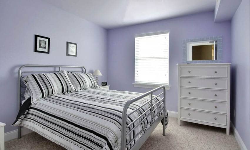 Girls bedroom with light purple paint and white dresser