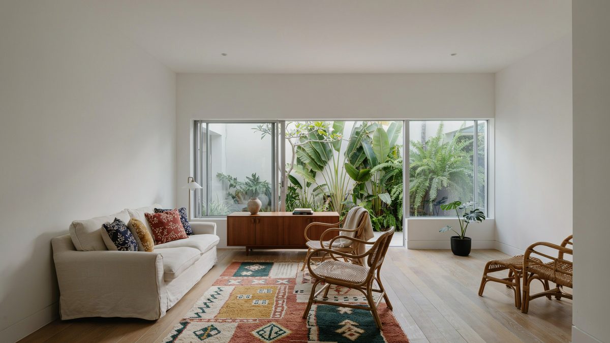 High ceiling room with large glass windows and bent rattan chairs