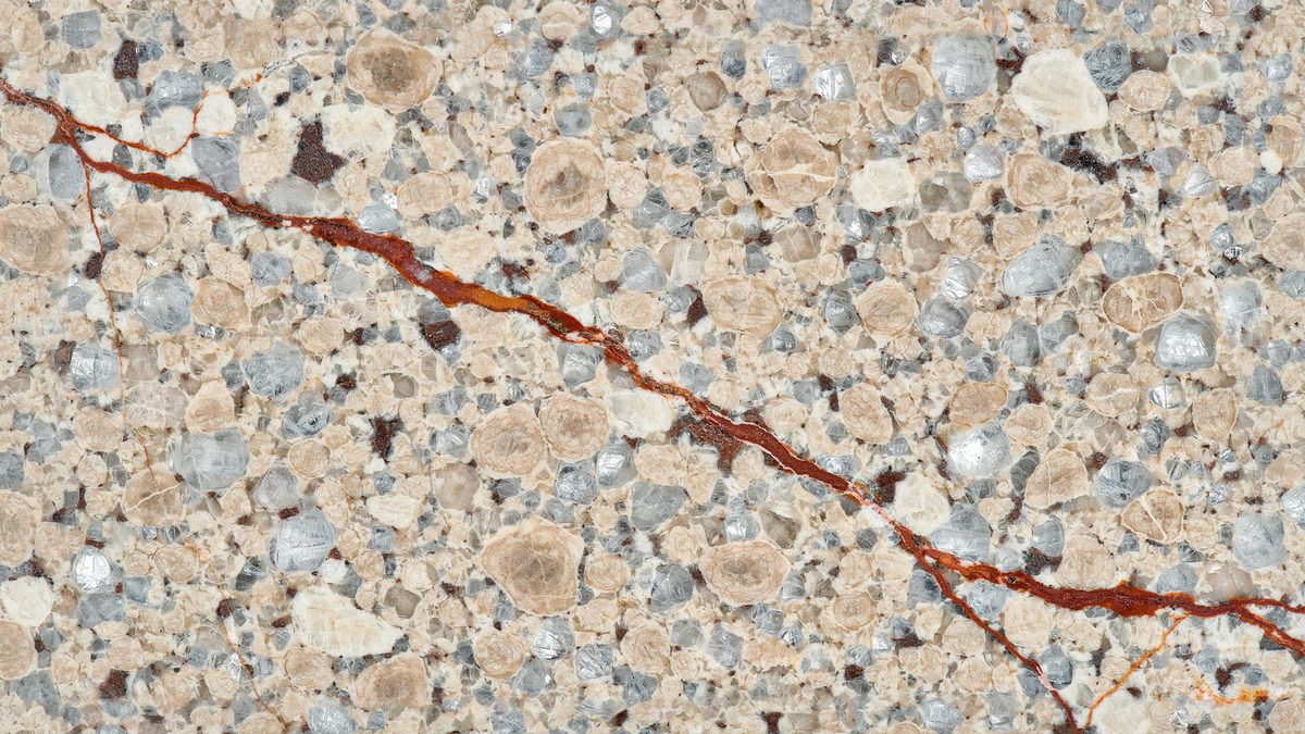 Ivory and taupe pebbled stone broken by a single burnt sienna streak