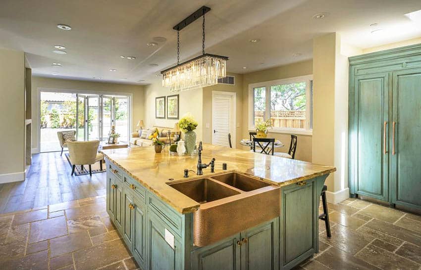 Kitchen with green painted cabinets with distressed finish and copper sink