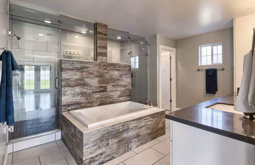 Bathroom with two matching showers and sintered stone clad tub