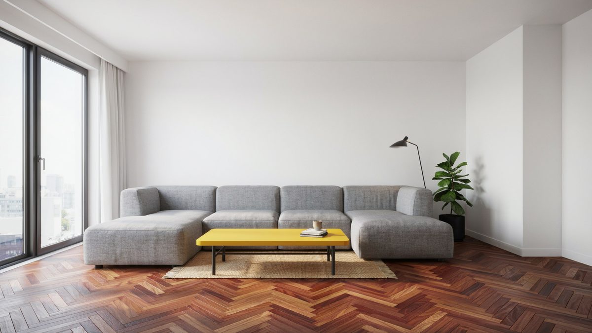 Room with herringbone parquet flooring with bright yellow table