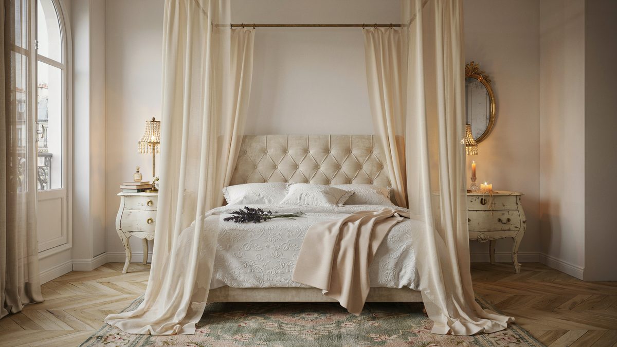 Tufted headboard framed by flowing sheer canopy curtains and gold oval mirror