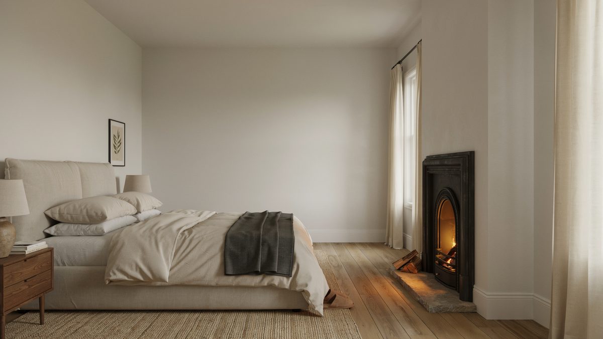 Small black iron stove glowing at the far end of a pale minimalist bedroom