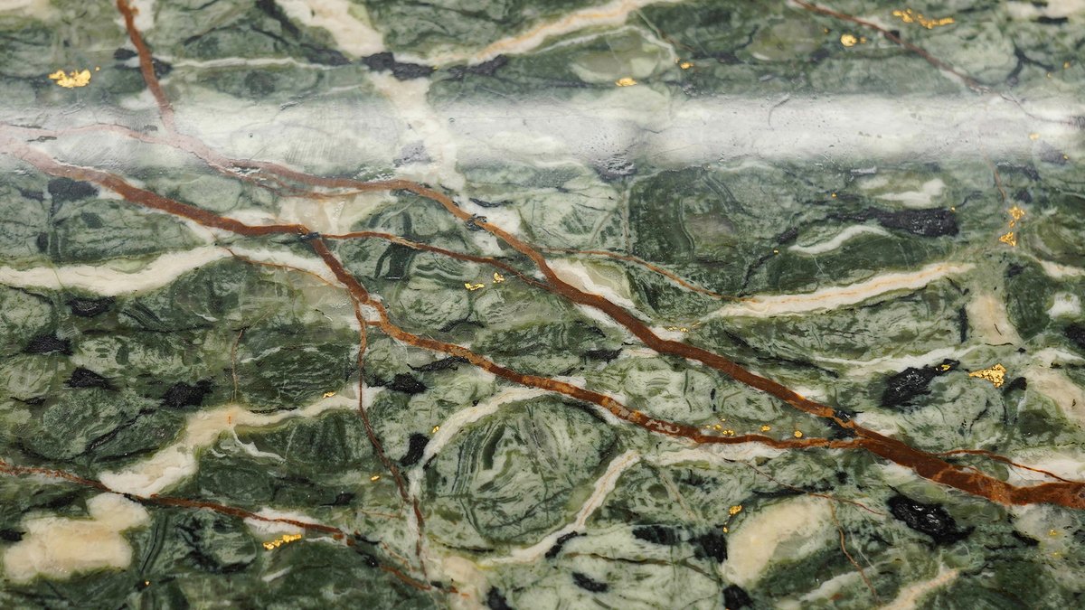 Rainforest green slab with moss swirls and rust brown branching veins