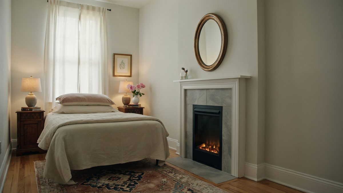 Compact grey marble surround with a white mantel beneath a round gilt mirror