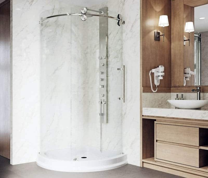 Curved shower with ceramic wash basin on vanity countertop