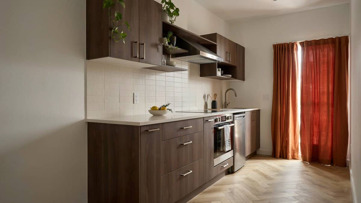 Custom dark wood cabinetry stepping in height beside a curtained entryway