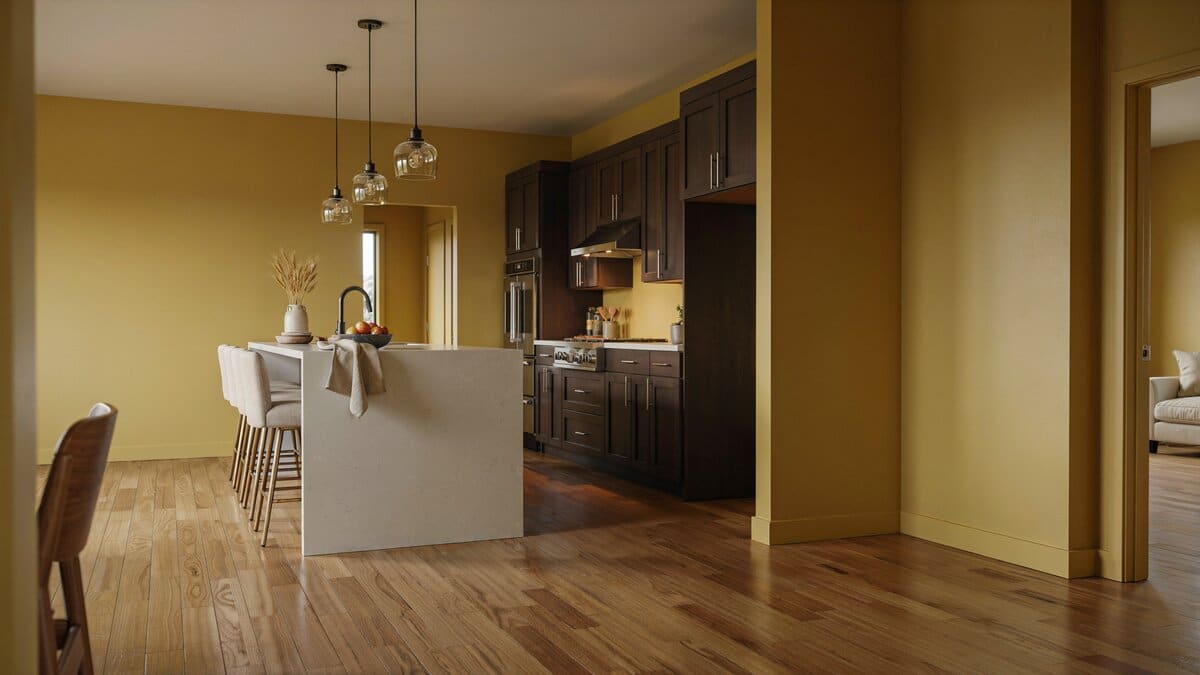 Mustard walls framing an island and chandelier above rich hickory boards