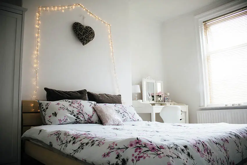 Teen girls bedroom with hanging lights on wall above bed