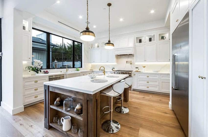 Traditional kitchen with carrara marble countertops, white cabinets and wood floors