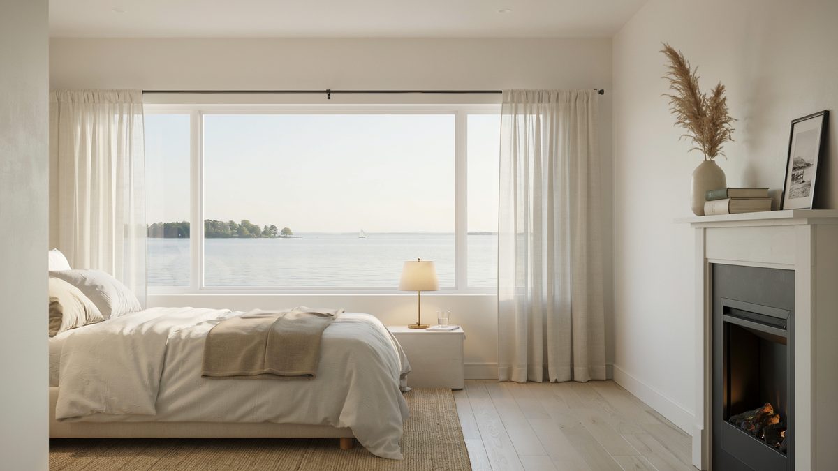 White mantel firebox next to a picture window framing calm open water