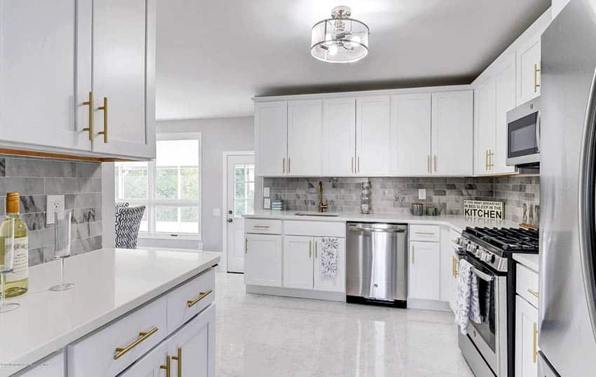 Minimalist kitchen with marble tile floors and backsplash