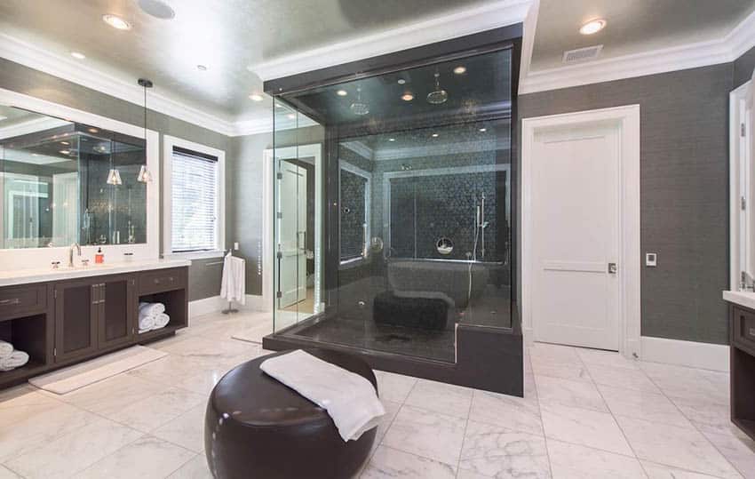 Bathroom with honed Bianco Carrara marble, black tiles and dual rainfall shower