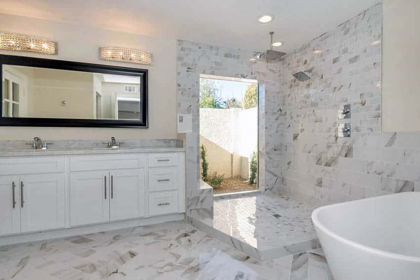 Bathroom with marble floors and walls in walk in rainfall shower