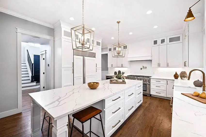 Beautiful kitchen with calacatta nuvo quartz countertops white shaker cabinets gold hardware finishes