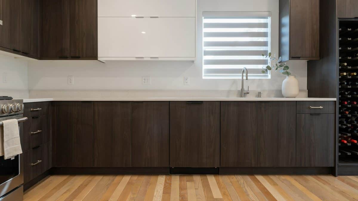 Dark walnut base cabinets with one white gloss wall unit and a built in wine rack