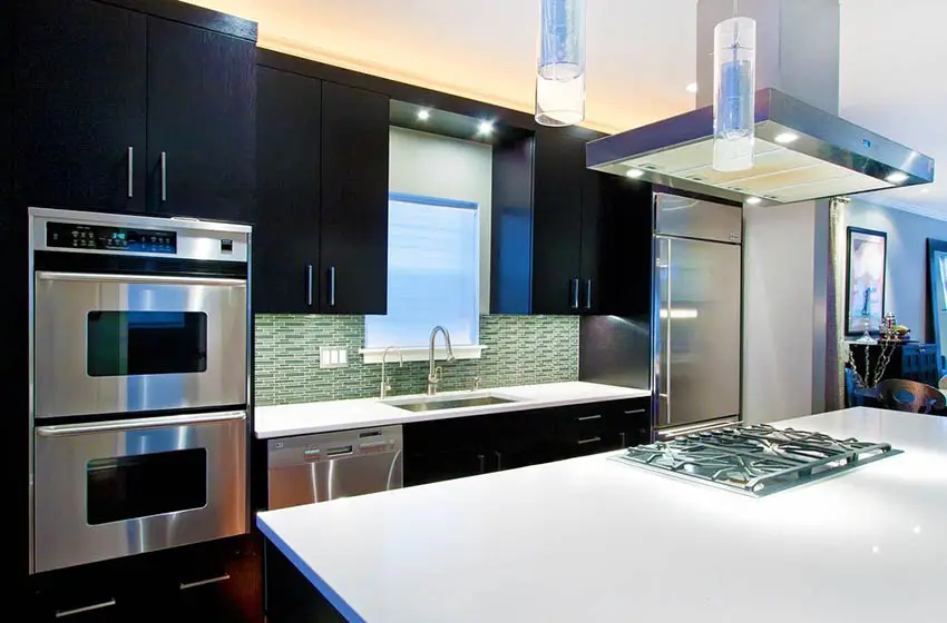 Contemporary kitchen with super white quartz glass tile backsplash and dark wood cabinets