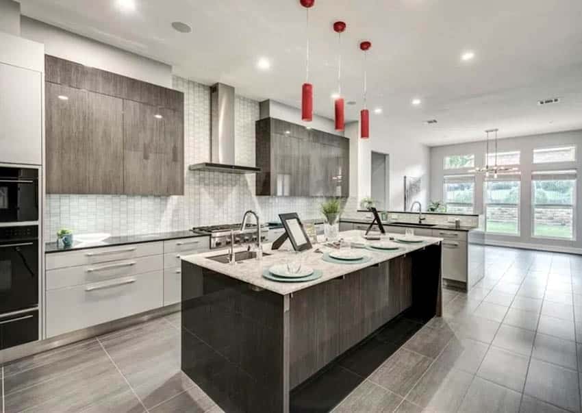 Kitchen with peninsula breakfast bar and island with pendants