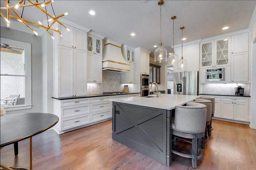 Contemporary two tone kitchen with gray hue island, white tone cabinets and black and white countertops