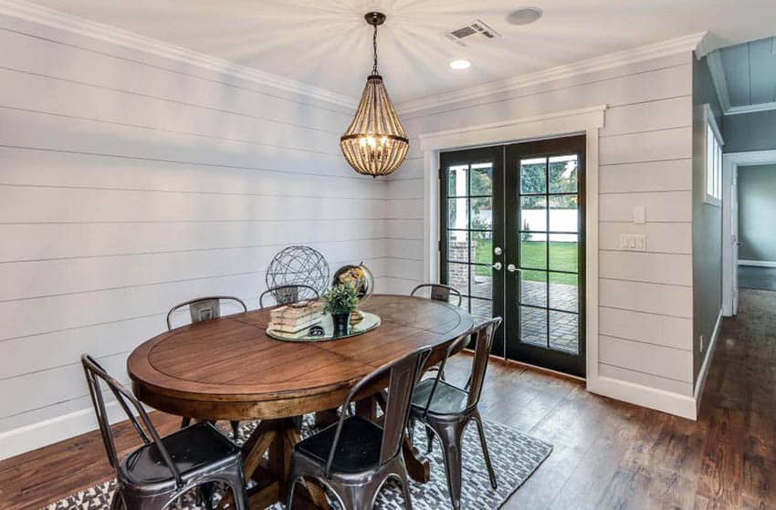 Cottage dining room with metal exterior french doors