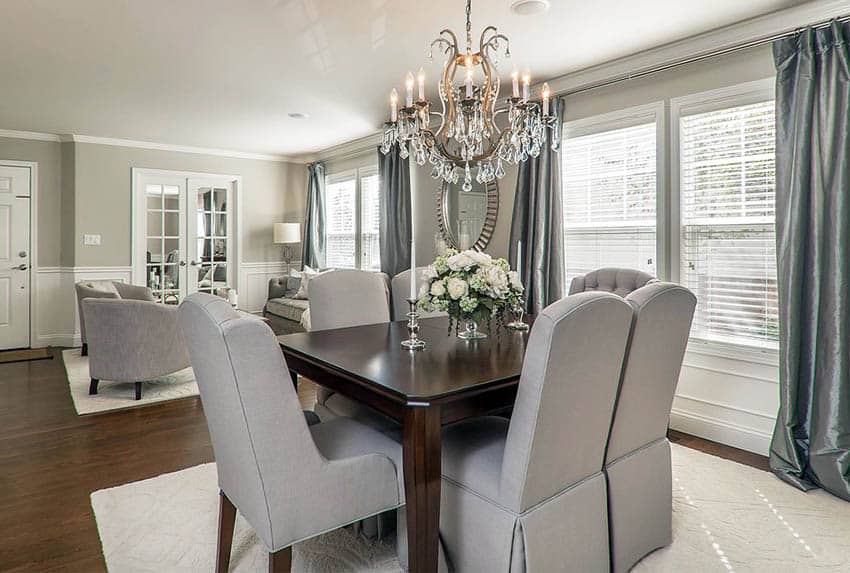 Dining room with mirrored french doors and chandelier