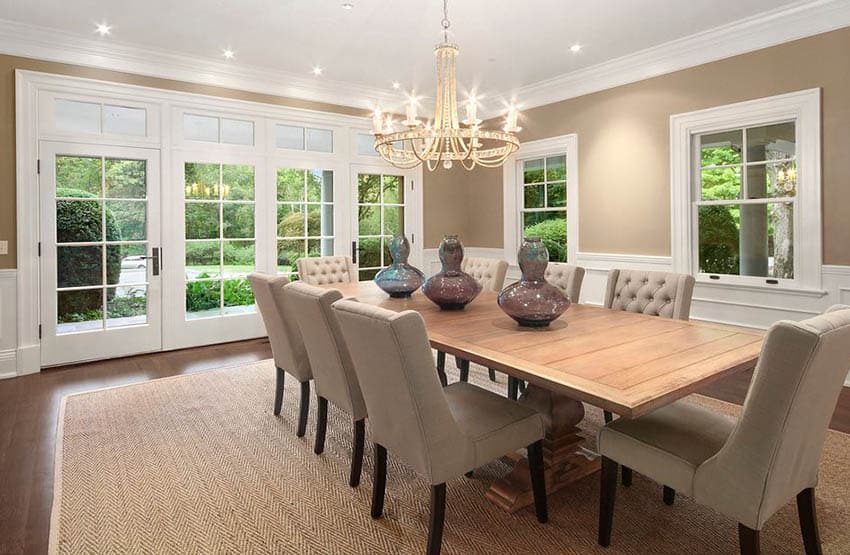 Dining room with white french doors, reclaimed dining table and chandelier