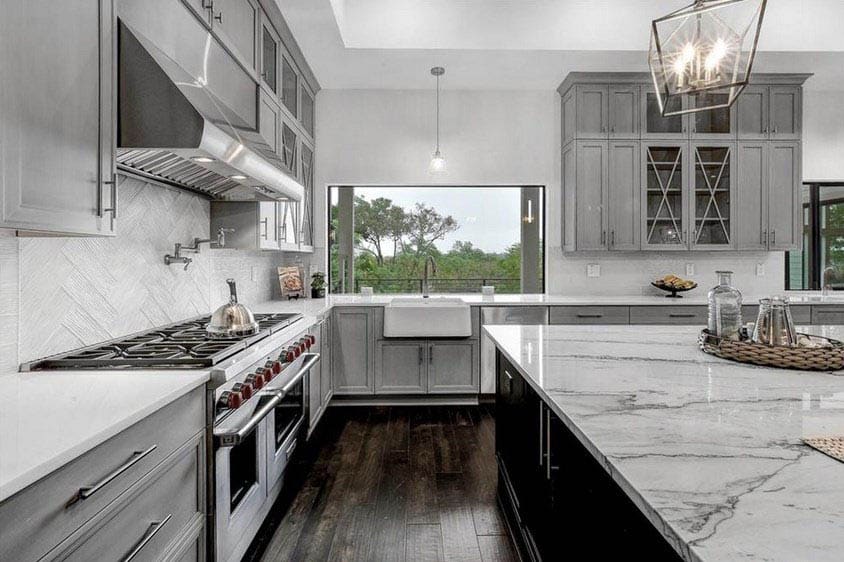 Kitchen with light gray cabinets and quartz slab countertops