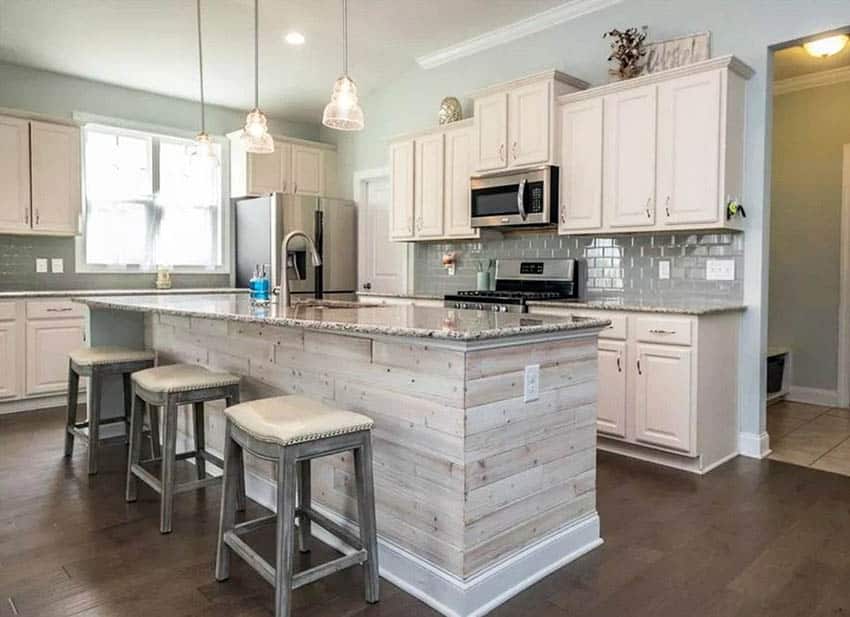 Country kitchen with wood plank island and granite countertops