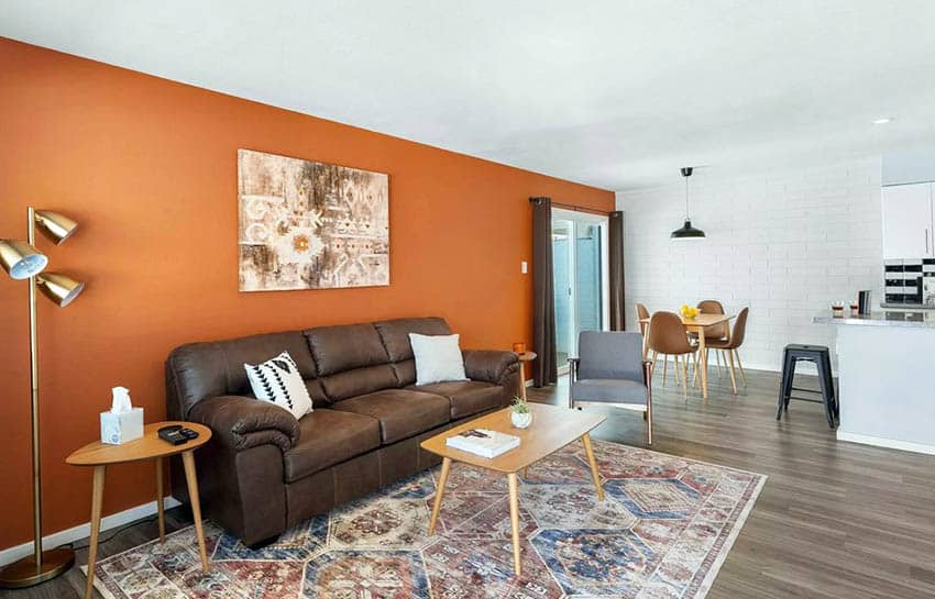 Living room with brown leather sofa and citrus wall paint
