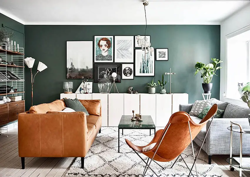 Living room with green color paint and brown leather sofa