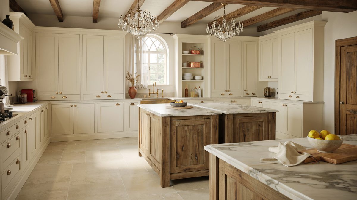 Cream cabinetry with twin rustic wood islands under two crystal chandeliers