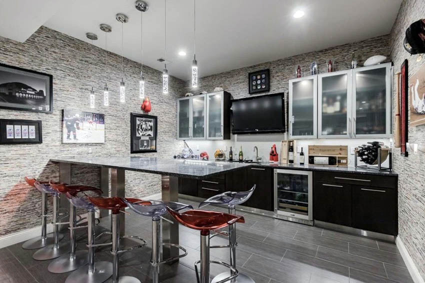 Bar with peninsula countertop and acrylic stools and black cabinets