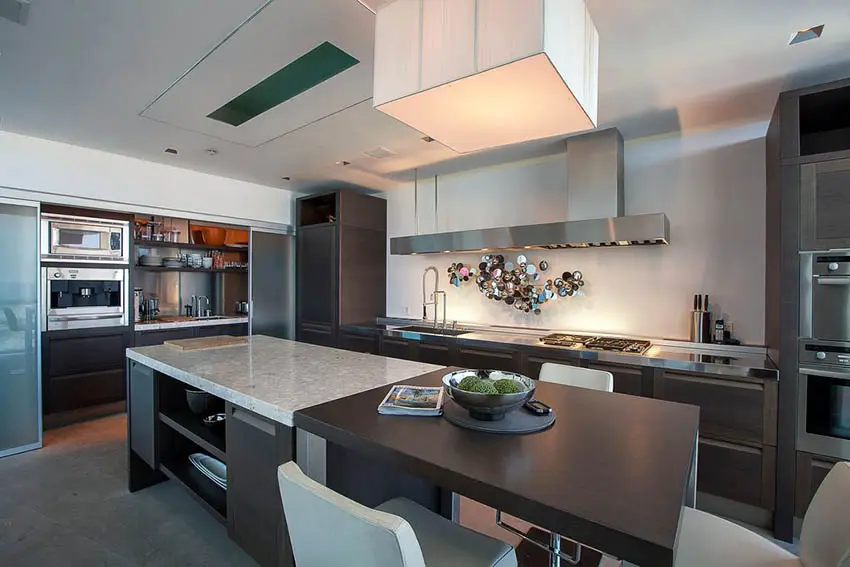 Modern kitchen with l shape and rectangular island with two types of countertops