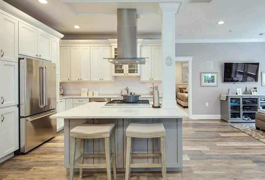 Open room kitchen with gray toned island and off-white hue cabinets