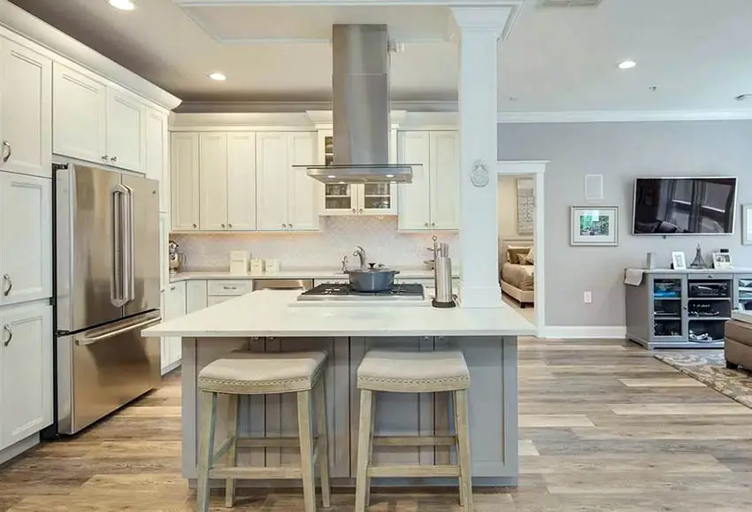 Small l shaped kitchen with white cabinets and gray island quartz countertops