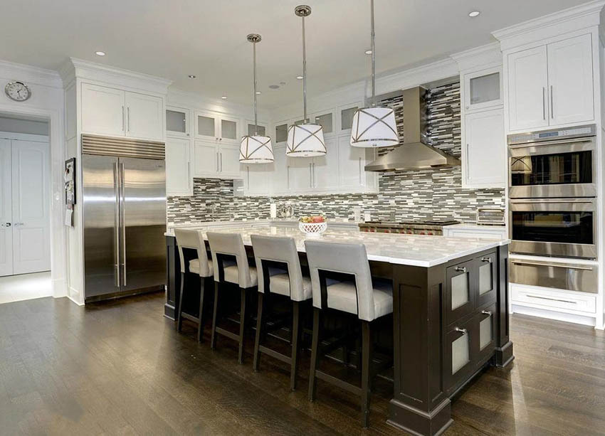 Traditional kitchen with white cabinets and dark wooden island mosaic backsplash