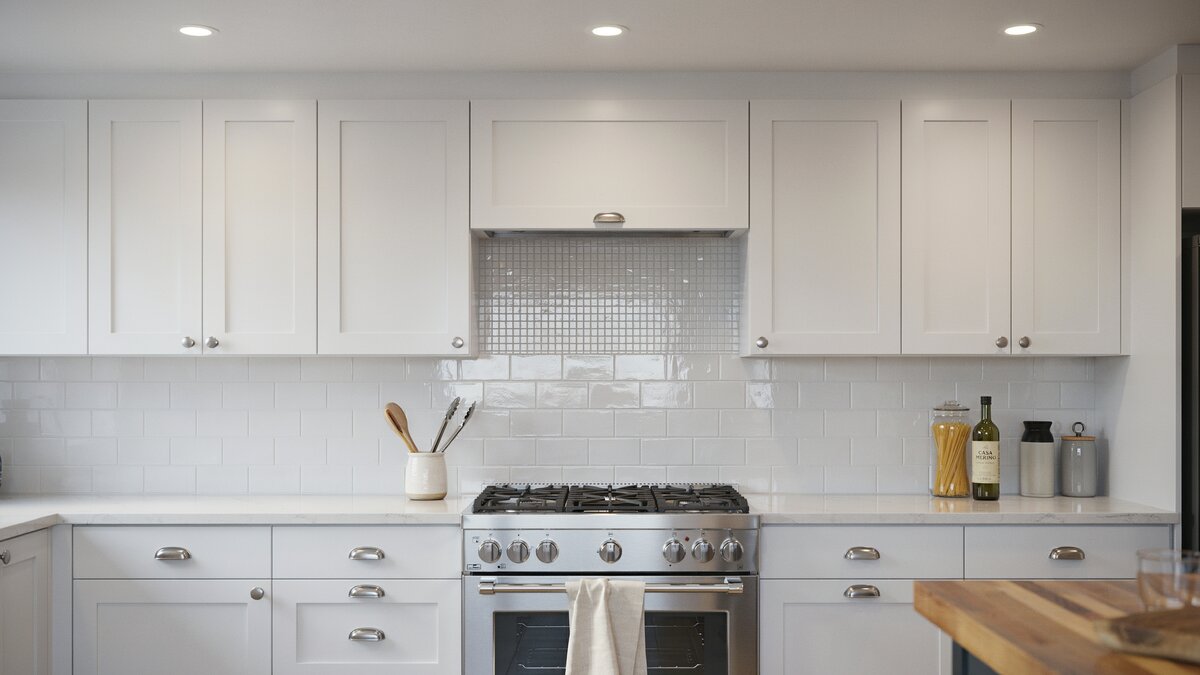 Glossy metallic mosaic square breaks up white subway tile above the range