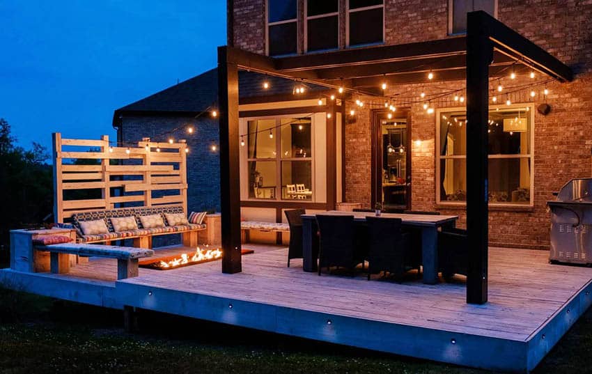 Wood deck with pergola, sunken fire pit, hanging lights and outdoor dining table