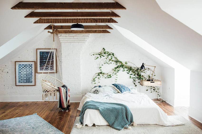 Attic bedroom with slanted walls and exposed wood beams