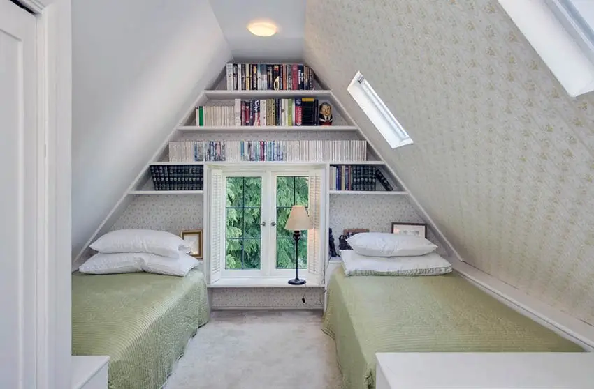 Attic guest bedroom with built in bookshelves and bed under dormers