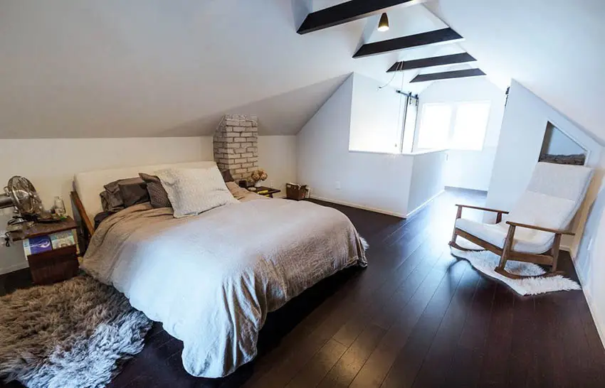Attic master bedroom with exposed brick wood beams and wall niches