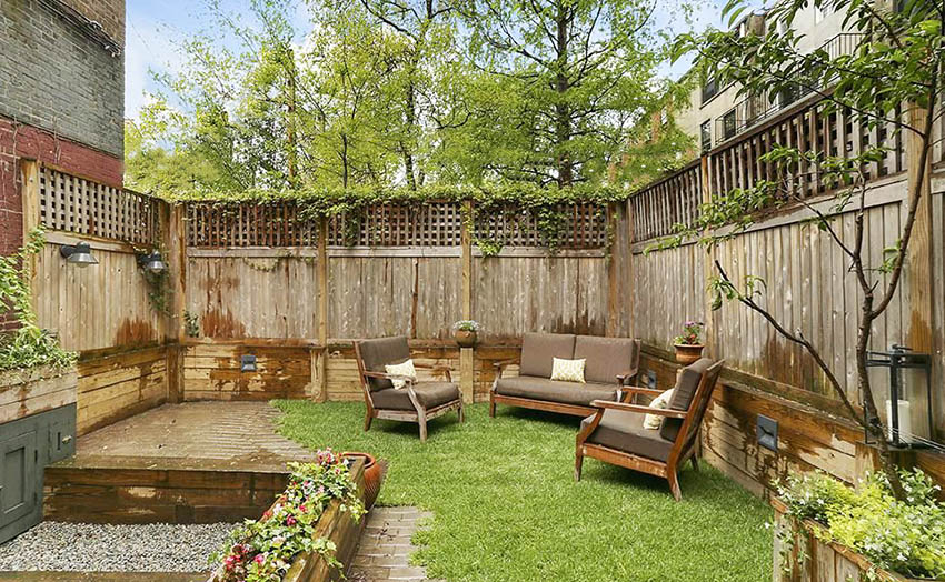 Backyard with wood privacy fence with lattice top with climbing plants