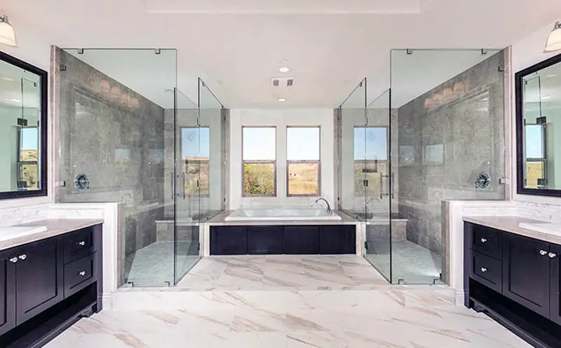 Bathroom with his and her showers