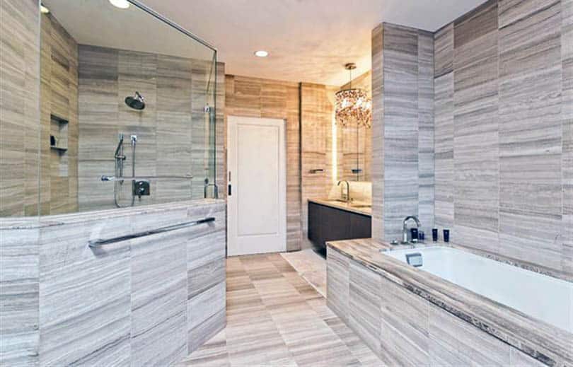 Bathroom with half glass wall and chandelier