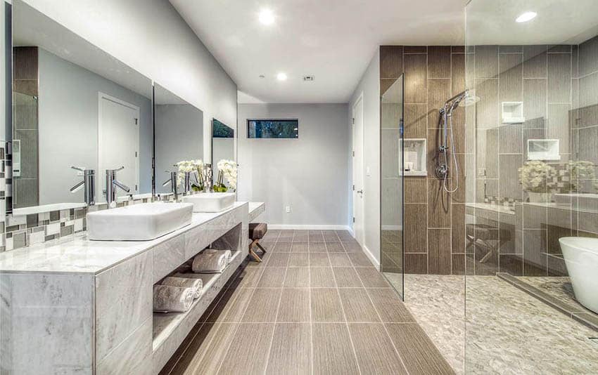 Shower with brown vertical tiles on walls and recessed lighting