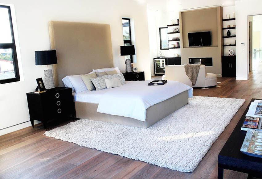 Gray bed, black night stands, lamp and area rug
