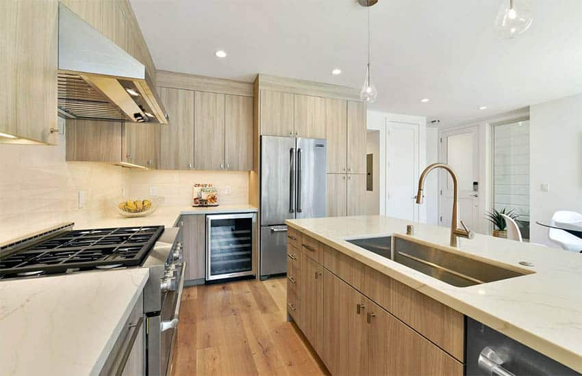 Kitchen with gold faucet and cream quartz countertops