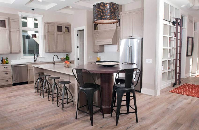 Contemporary kitchen with white oak wide plank floors and round table next to island